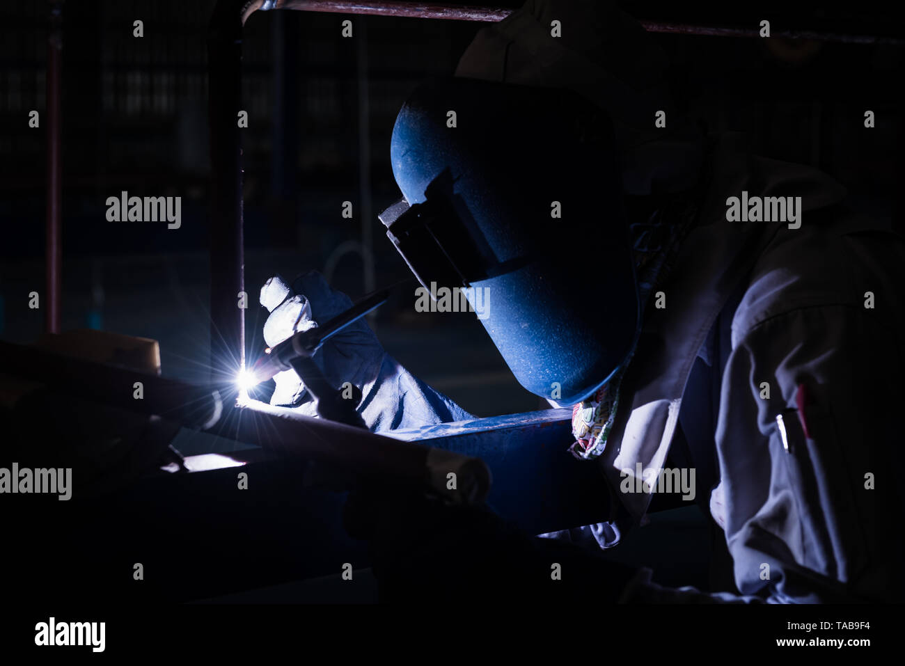 Welding steel pipe with Mig-Mag method for industrial work. Gas metal arc welding Stock Photo