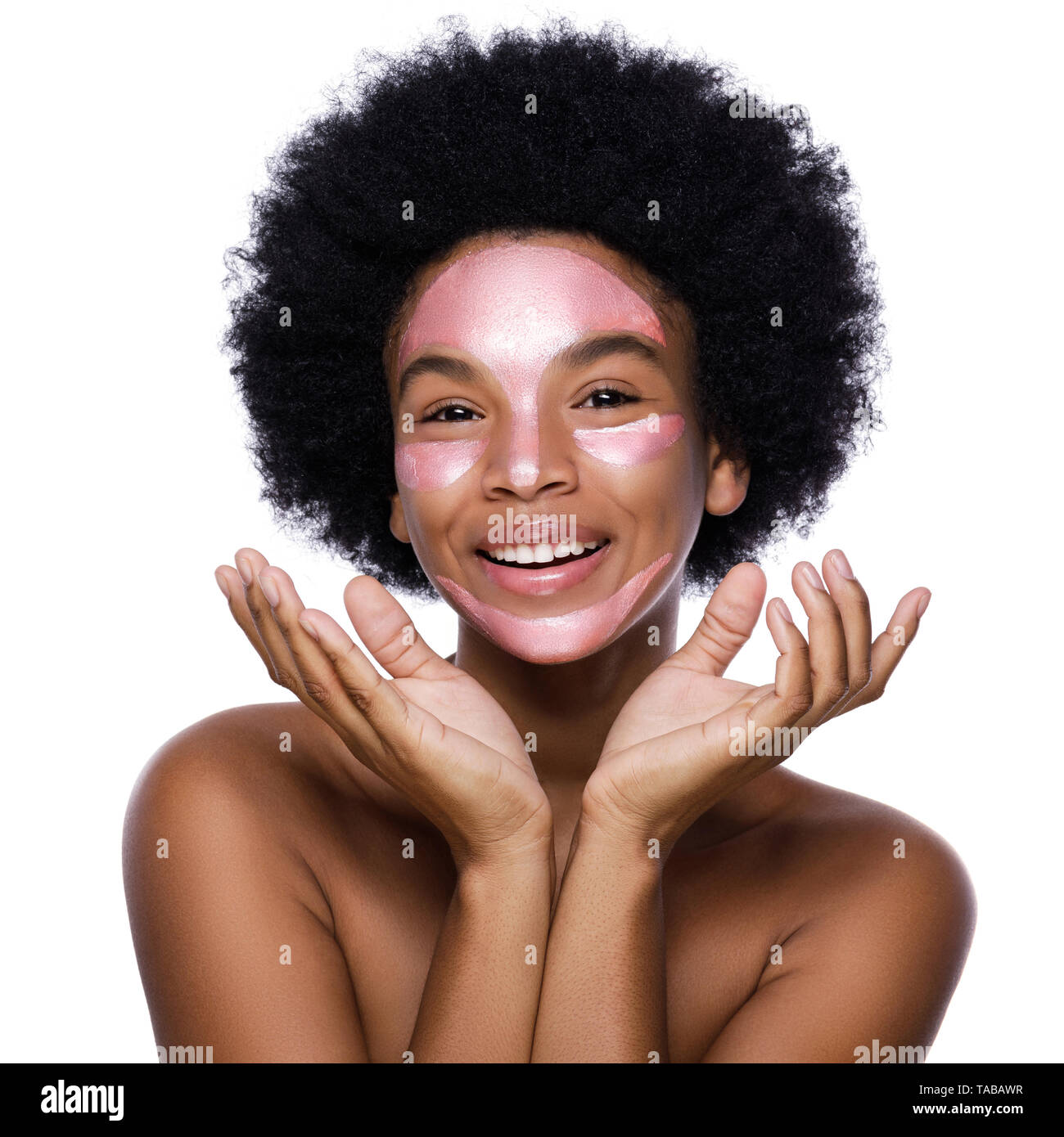 Young African woman with a purifying mask on her face over white background Stock Photo