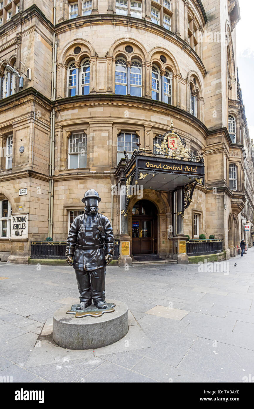 Statue of citizen firefighter outside entrance to Grand Central Hotel