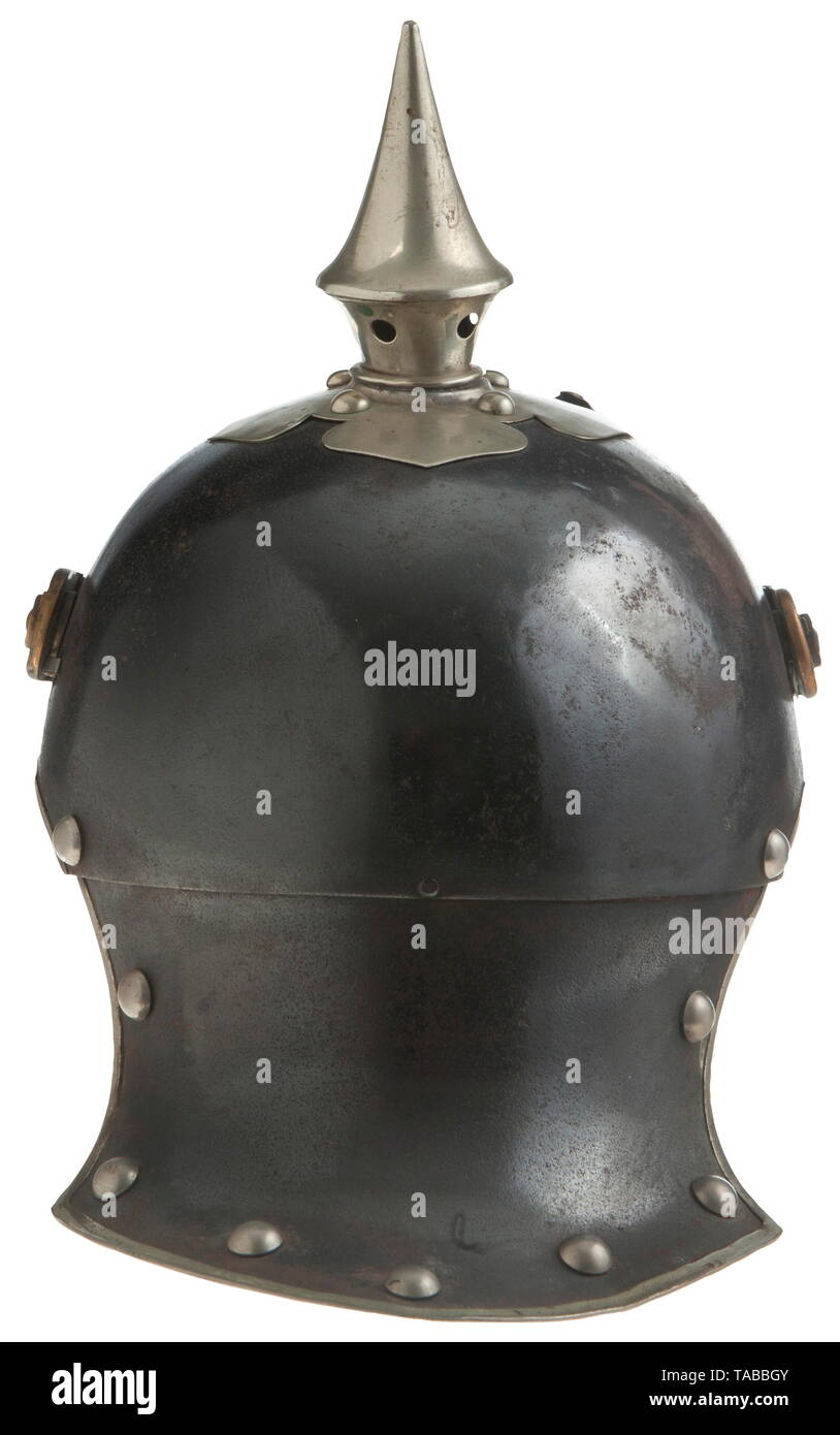 An Imperial German helmet M 1905 for enlisted men of mounted rifles 1-4 regiments Metal lobster tail body with blued finish showing some rust and pitting, body dated '1914' and maker marked, black leather lining, bright silver dragoon eagle front plate attached by loops with leather straps, silver spike, cross base and body trim, large rounded brass chinstraps and 91 lugs, extra mounting holes in body behind 91 lugs, missing cockades. USA-lot, see page 4. historic, historical, Prussian, Prussia, German, Germany, militaria, military, object, objec, Additional-Rights-Clearance-Info-Not-Available Stock Photo