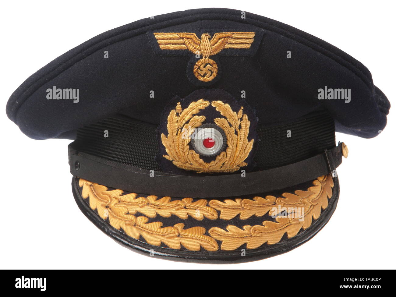 A Kriegsmarine visor cap for commodores and admirals Fine blue doeskin top with a horizontally ribbed black mohair centre band, gold cellon embroidered insignia, black vulcan fiber visor with applied double row of gold cellon embroidered oakleaves. Black patent leather chin strap secured by two small fire gilt buttons with an embossed fouled anchor and twisted rope design. Blue satin lining with diamond shaped moisture shield imprinted 'Erel Sonderklasse'. Complete with tan leather sweatband. USA-lot, see page 4. historic, historical, navy, naval forces, military, militaria, Editorial-Use-Only Stock Photo