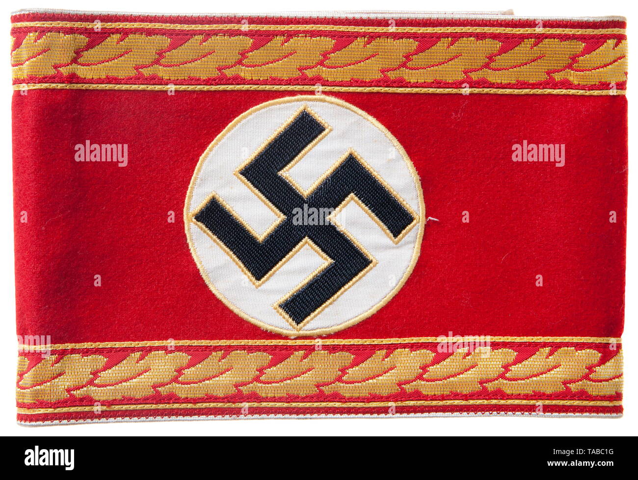 An NSDAP armband for 'Kreisleiter eines Hauptamtes' Red wool, separately applied white disc, multi-piece black swastika edged in gold woven cellon. Bordering top and bottom is a 18 mm wide machine woven horizontal strip of repeating oakleaves edged with gold cellon. Outer edges piped in white rayon. Reverse stamped with orientation stamp and 'oben'. Unsewn, length 52 cm. USA-lot, see page 4. historic, historical, 20th century, 1930s, party organisation, party organization, organisations, organizations, organization, organisation, party, parties, political party, German, Ger, Editorial-Use-Only Stock Photo