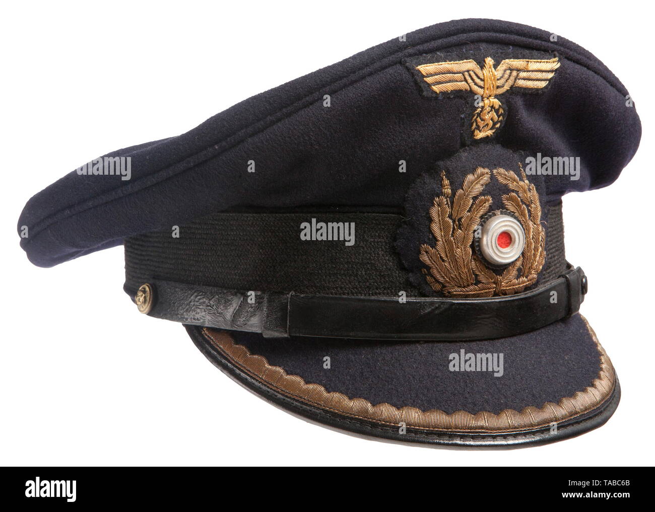 A named Kriegsmarine visor cap for Kapitänleutnant Götz von Hartmann Fine  blue doeskin top with a horizontally ribbed black mohair centre band, gold  bullion embroidered insignia with aluminium cockade, black vulcan fiber