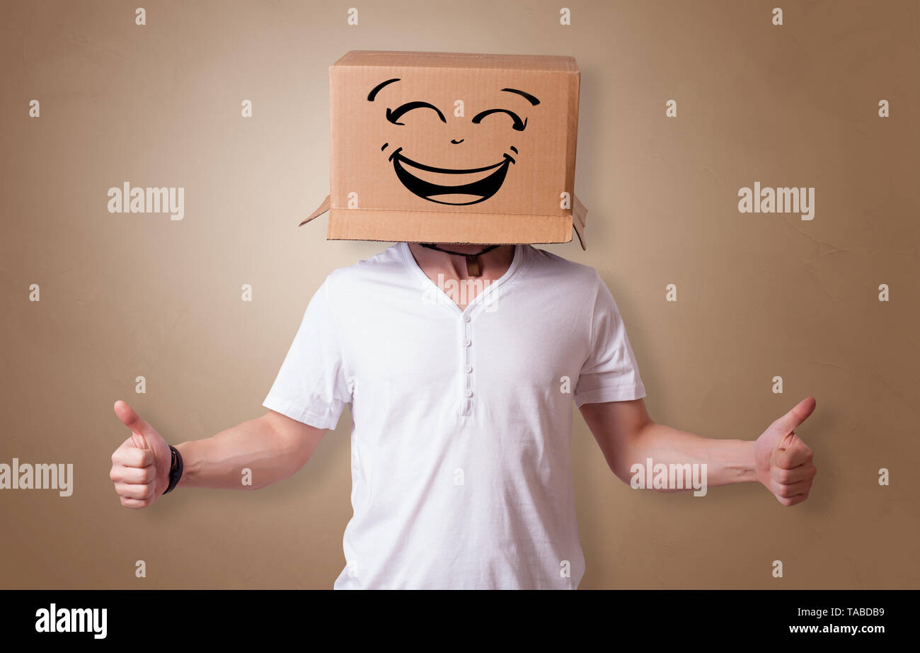 Young man with happy face illustrated cardboard box on his head Stock ...