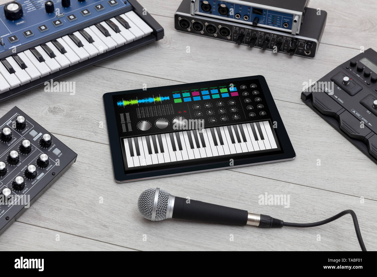 Piano synthesizer app on tablet and musical instrument concept Stock