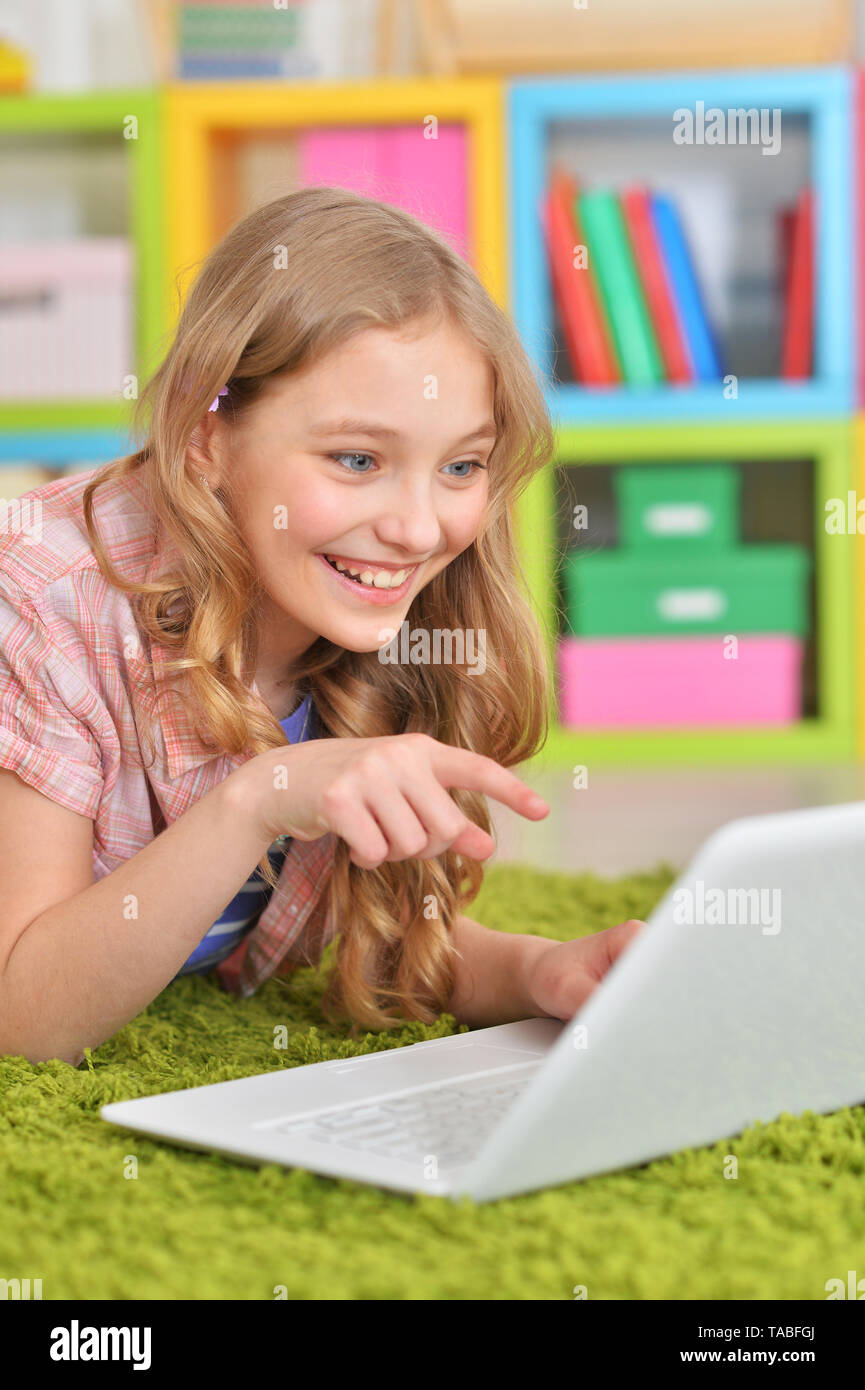 Portrait of emotional cute girl using laptop Stock Photo - Alamy
