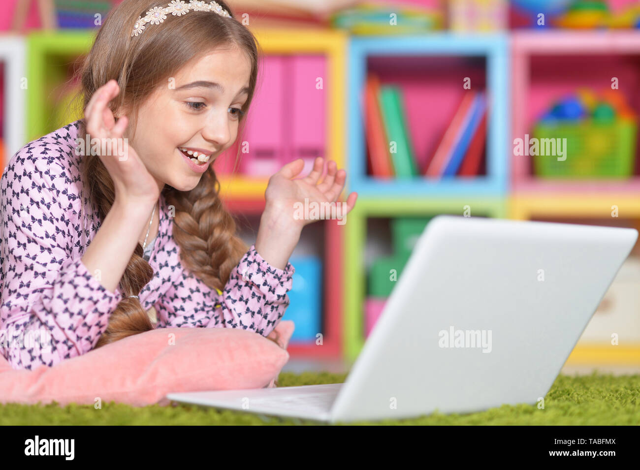 Portrait of emotional cute girl using laptop Stock Photo - Alamy