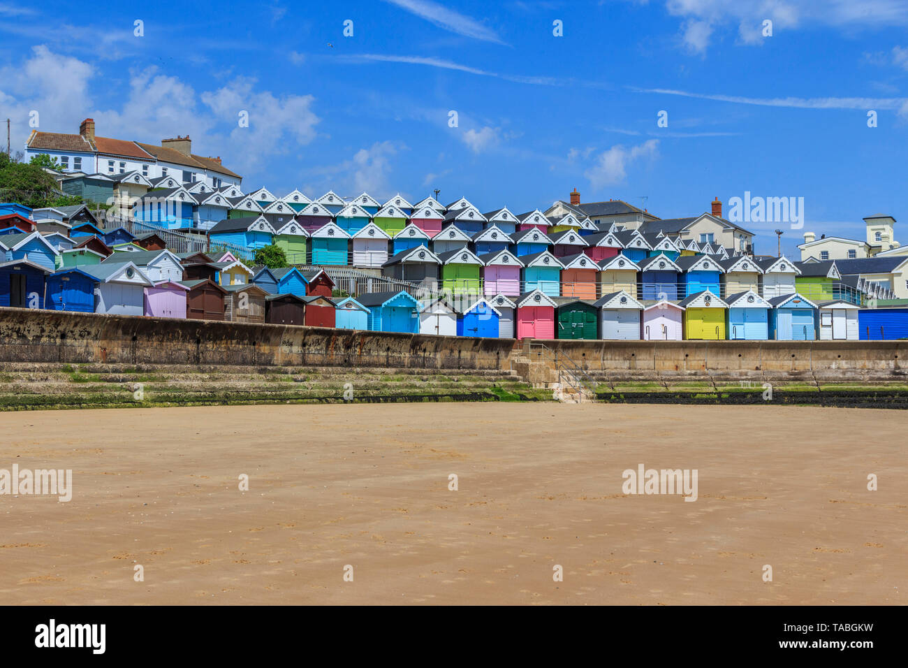 brightly coloured beach huts, very expensive property, seaside town of