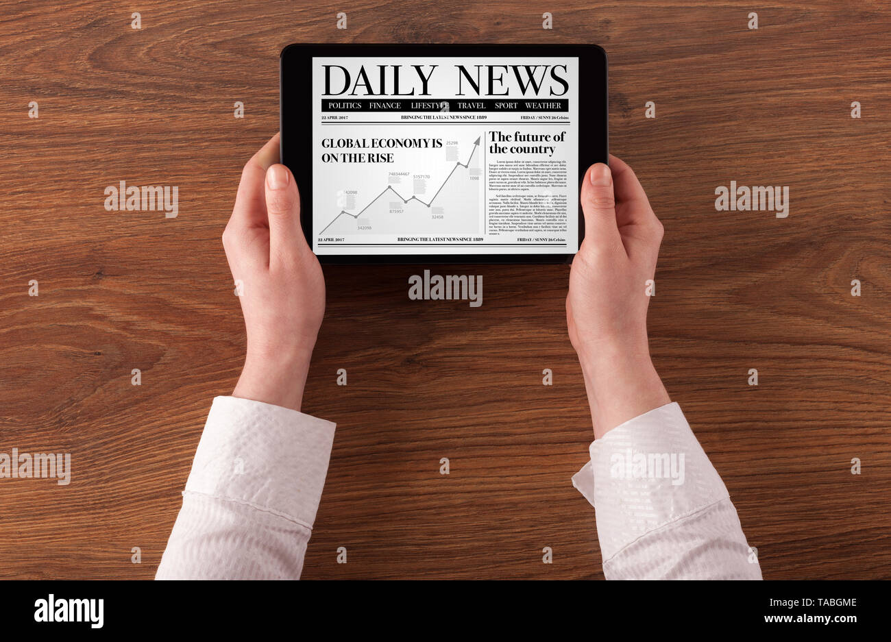 Hand with tablet reading news on tablet Stock Photo Alamy