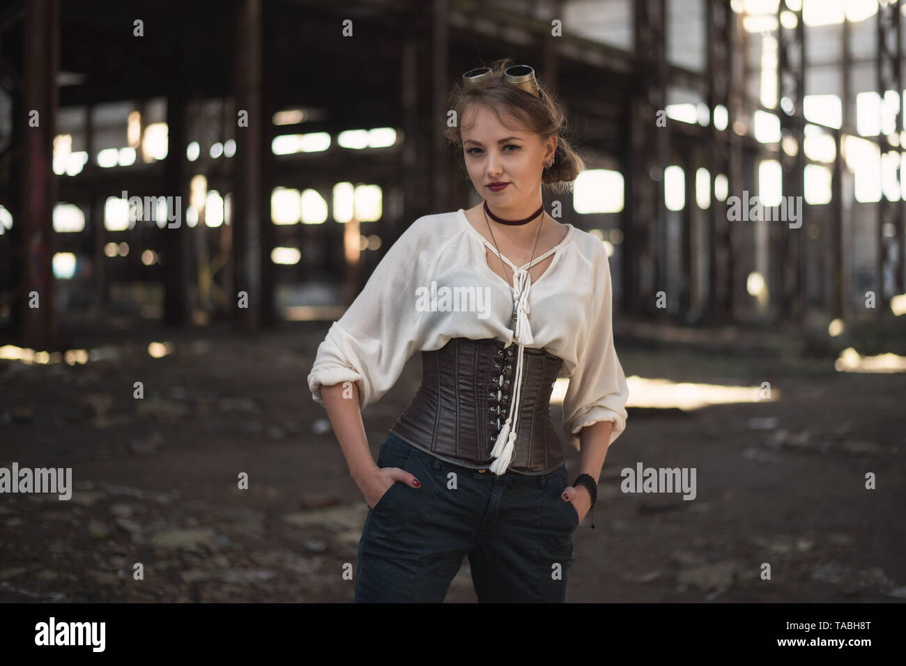 girl in a steampunk costume at an abandoned factory Stock Photo