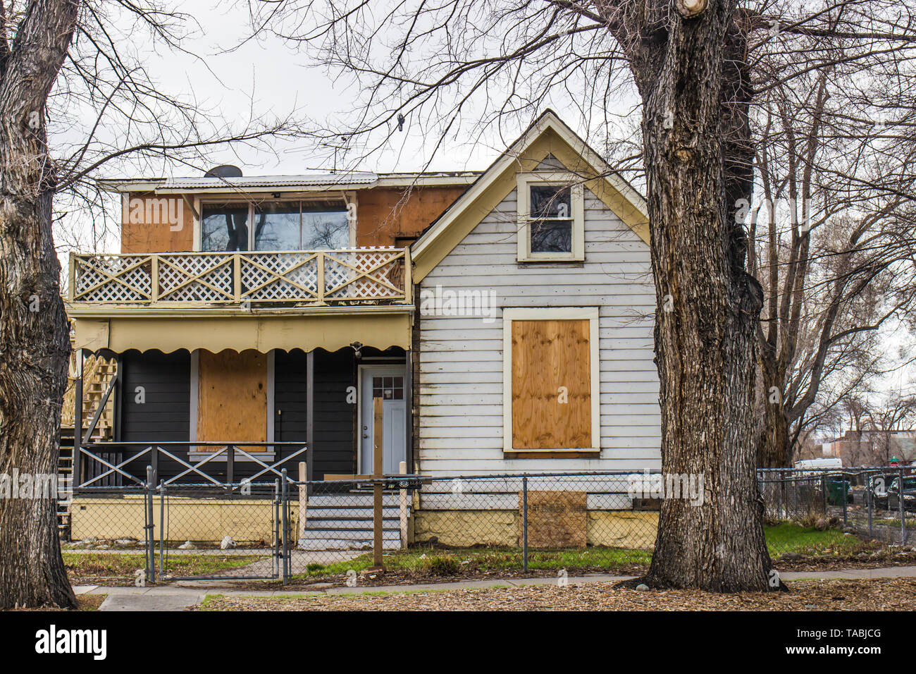 Abandoned Two Story House With Boarded Up Windows Stock Photo