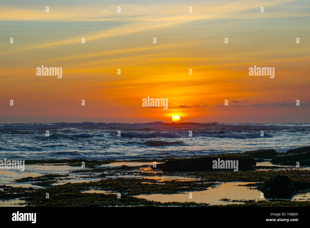 Sunset view from beach near Tanah Lot Temple in Bali Indonesia - travel  background Stock Photo - Alamy