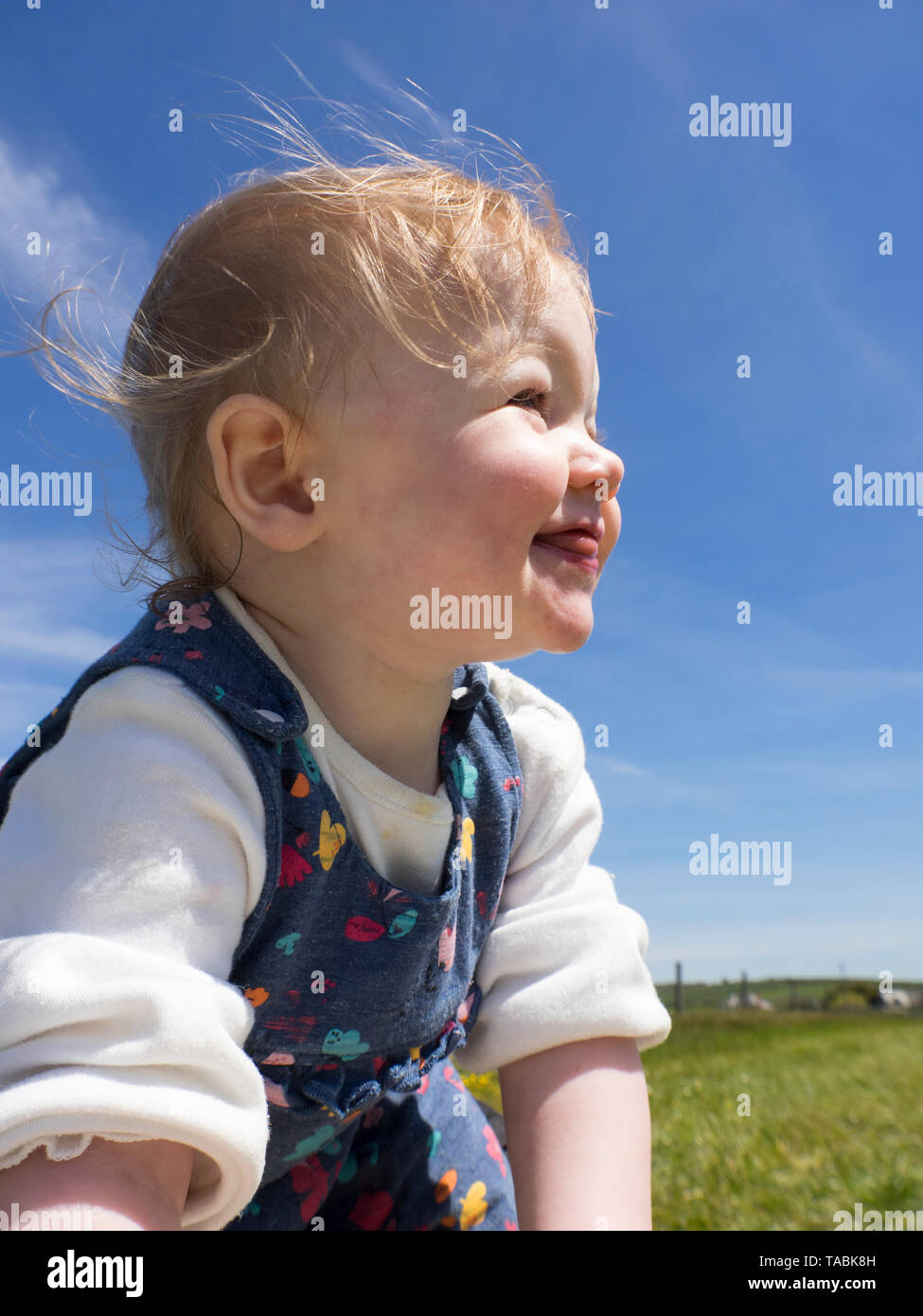 Baby girl in the sunshine, UK Stock Photo