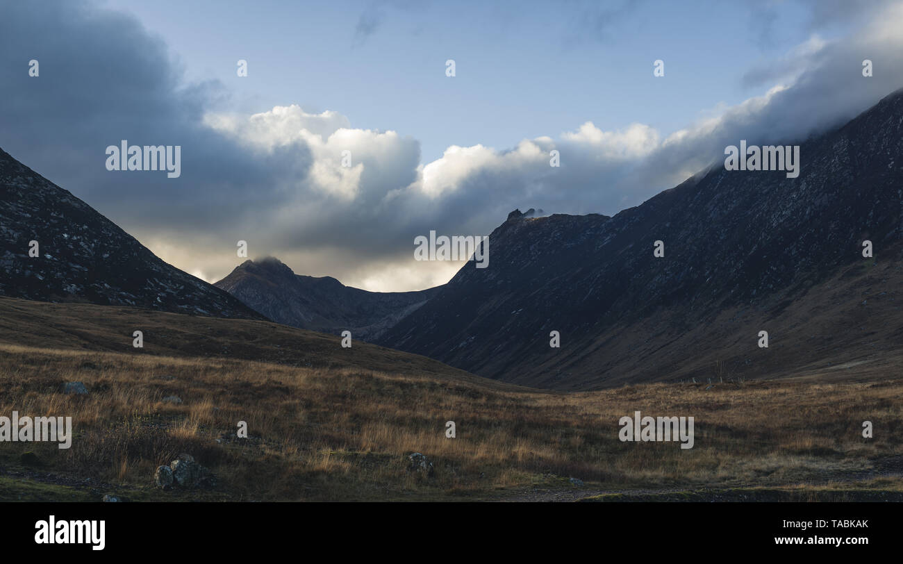 Landscape shot of a rugged mountain range against an unsettled sky. Stock Photo