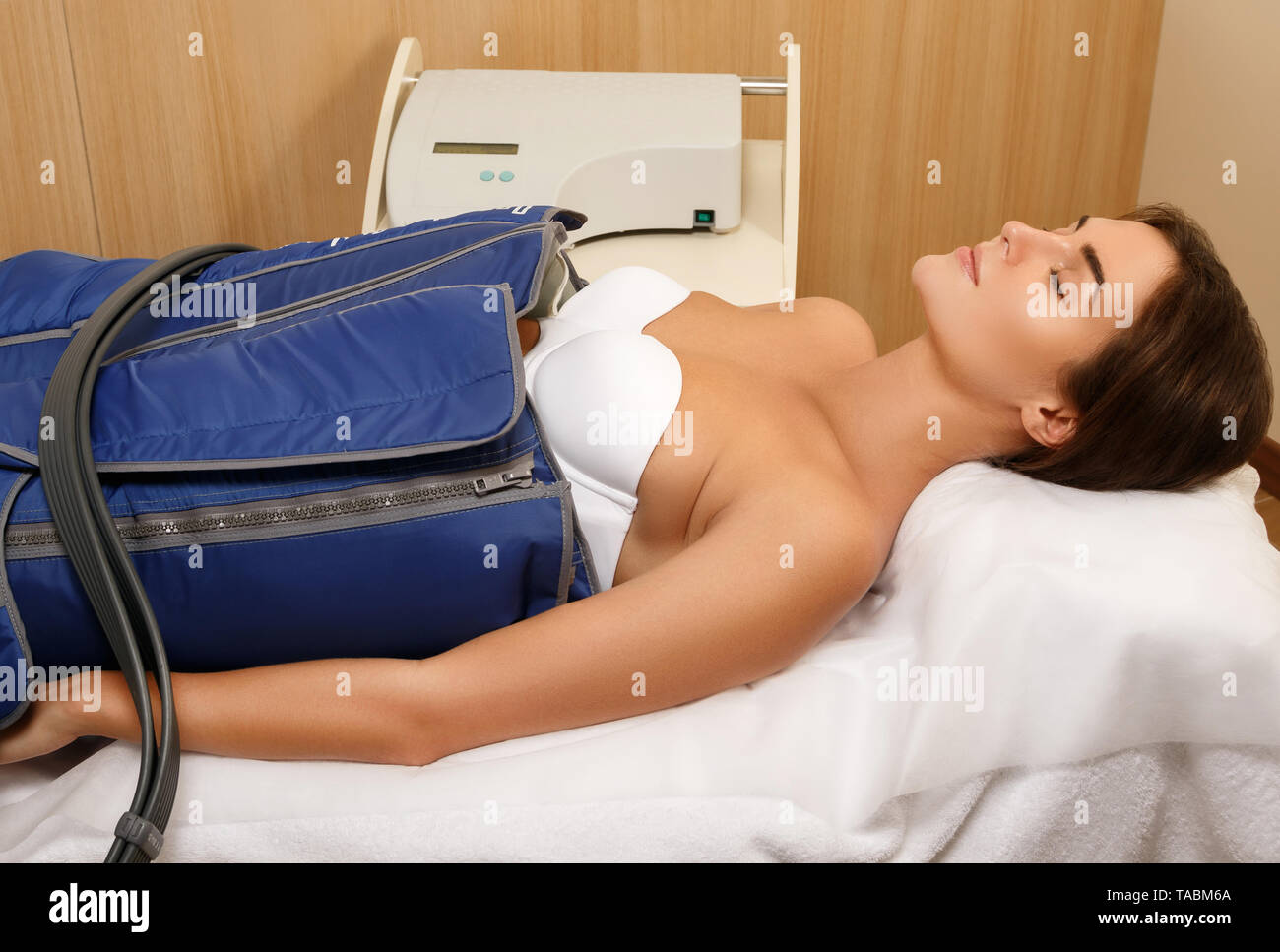 Woman in professional beauty clinic during automatic lymphatic drainage Stock Photo