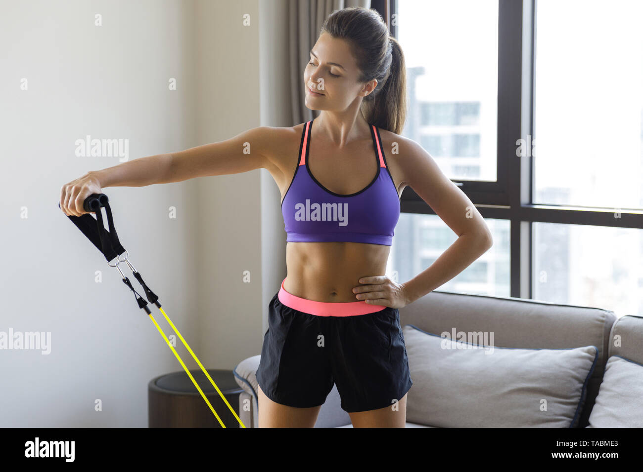 Woman during home workout with a rubber resistance bands Stock Photo
