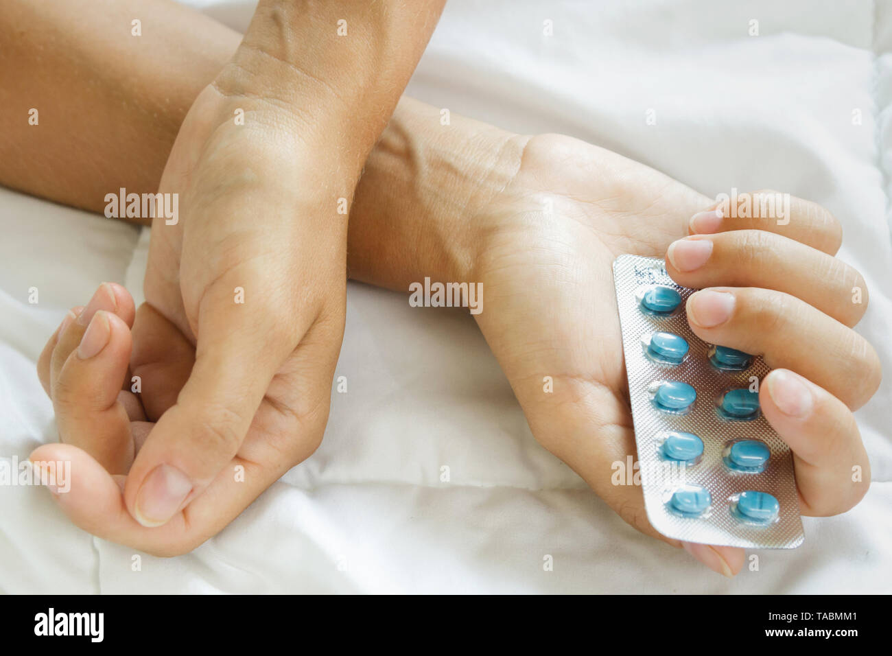 Female hands and blister pack with pills Stock Photo