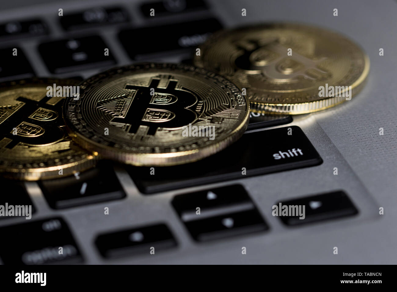 Bitcoin close up on computer keyboard. Investing in financial sector. Stock Photo