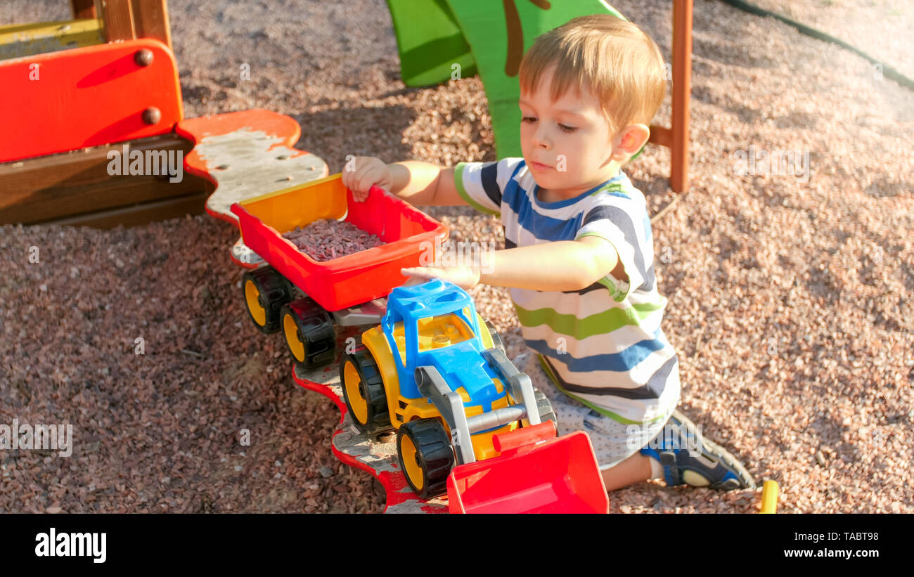 little boy with truck and trailer