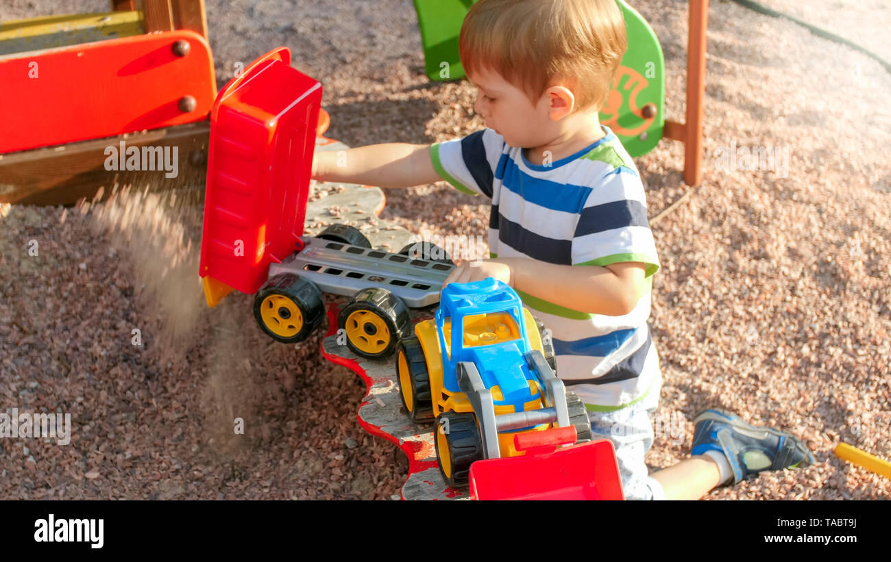 little boy with truck and trailer