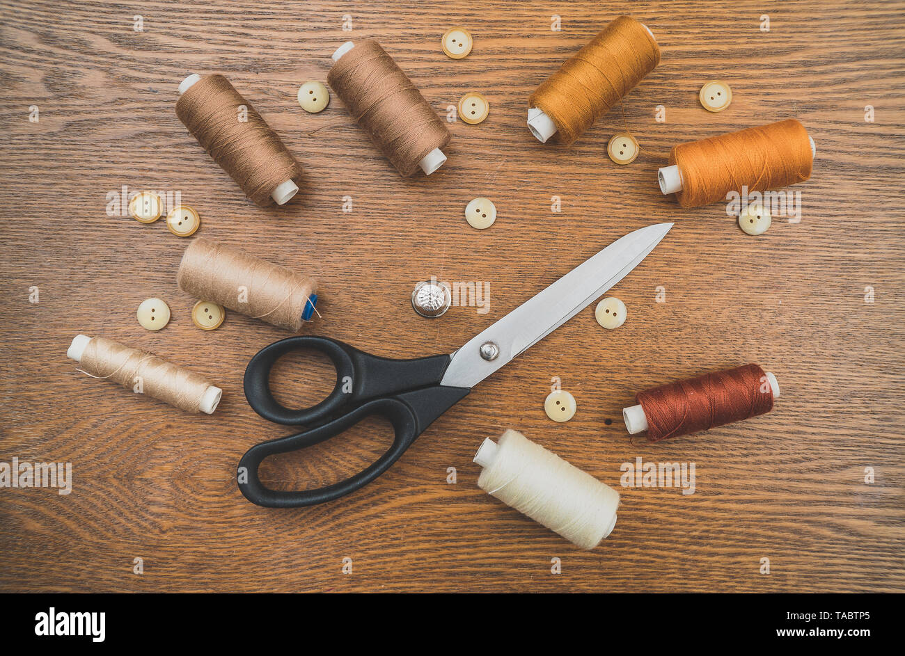 Sewing concept. Scissors, threads and buttons. Stock Photo