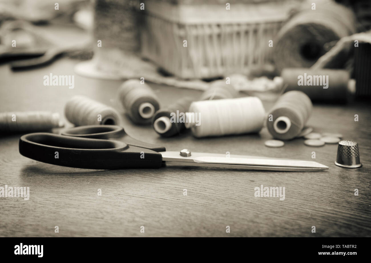 Sewing concept. Scissors, threads and buttons. Black and white. Stock Photo