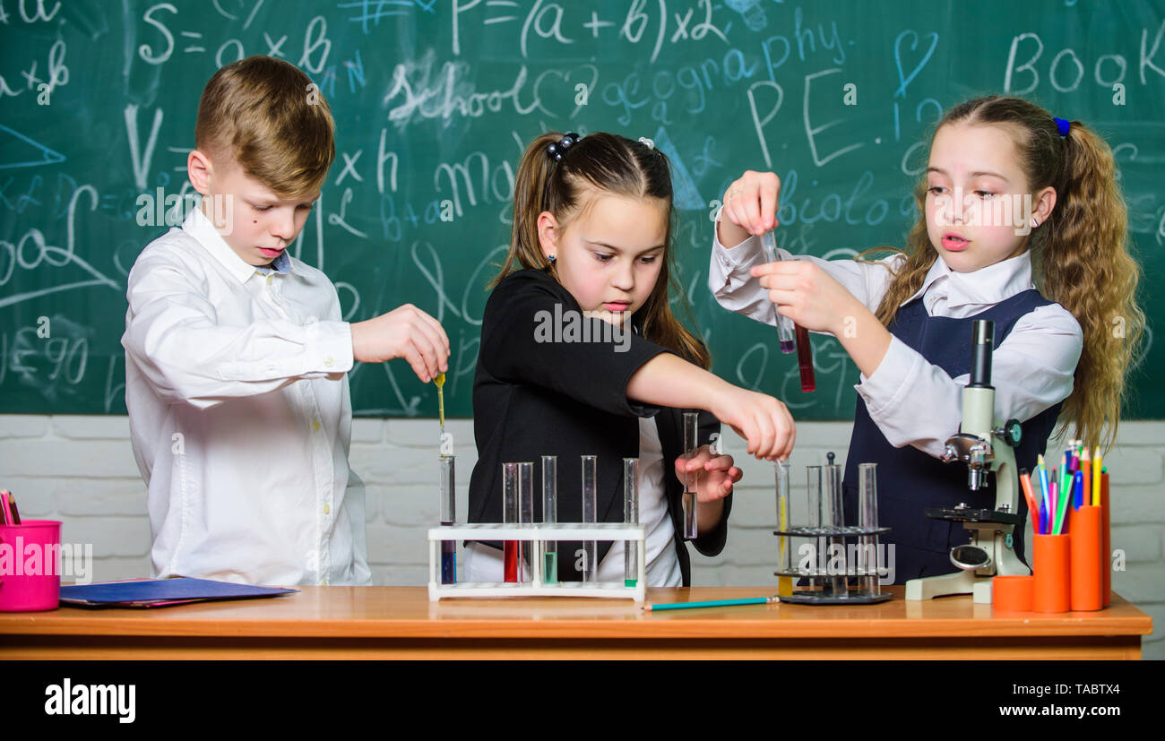 Study of liquid states. Group school pupils study chemical liquids