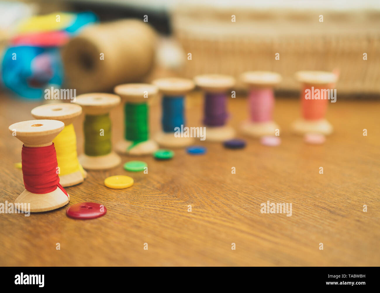 Sewing concept. Colorful buttons and thread spools. Stock Photo