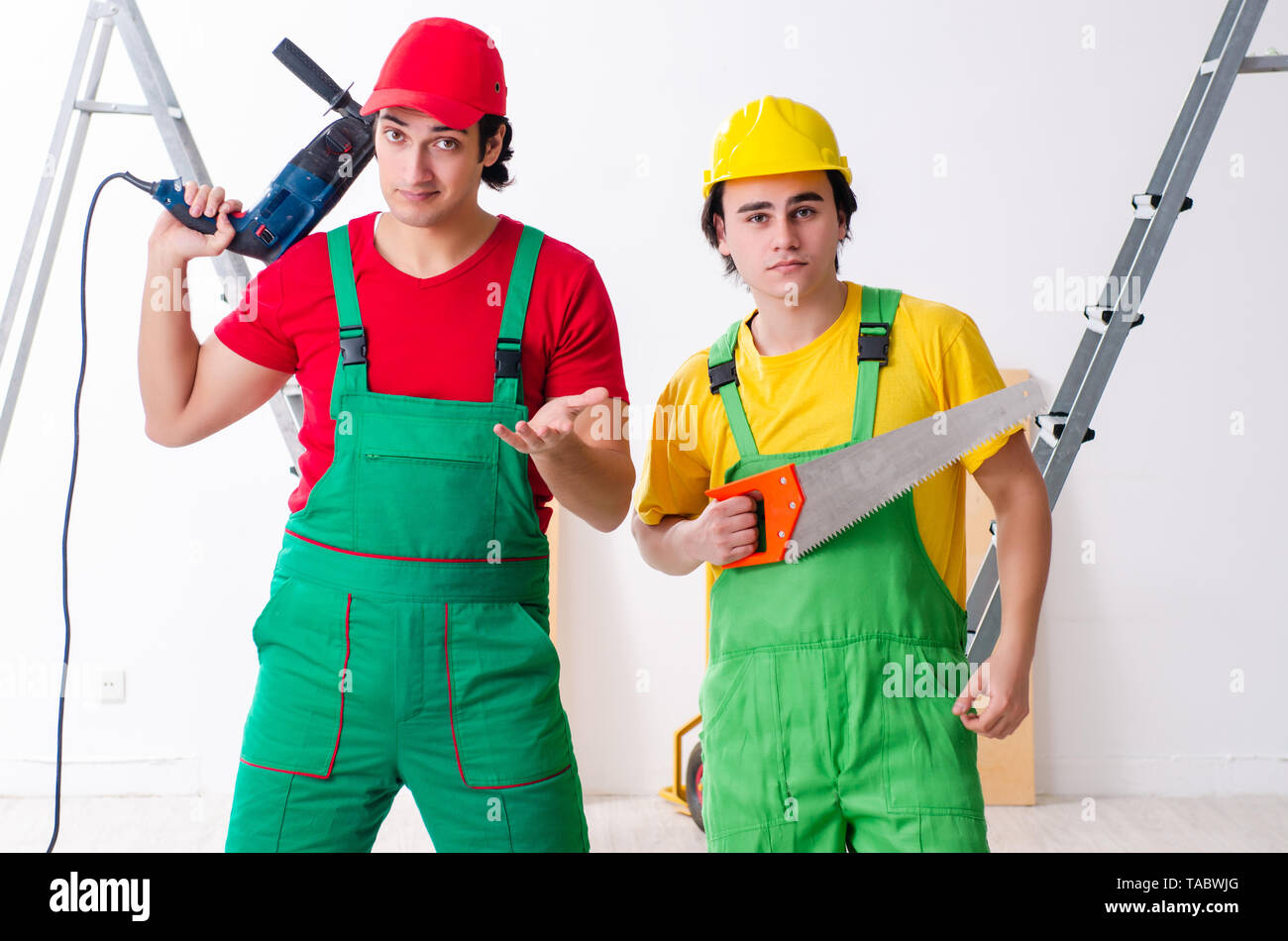 Two workers contractors working indoors Stock Photo