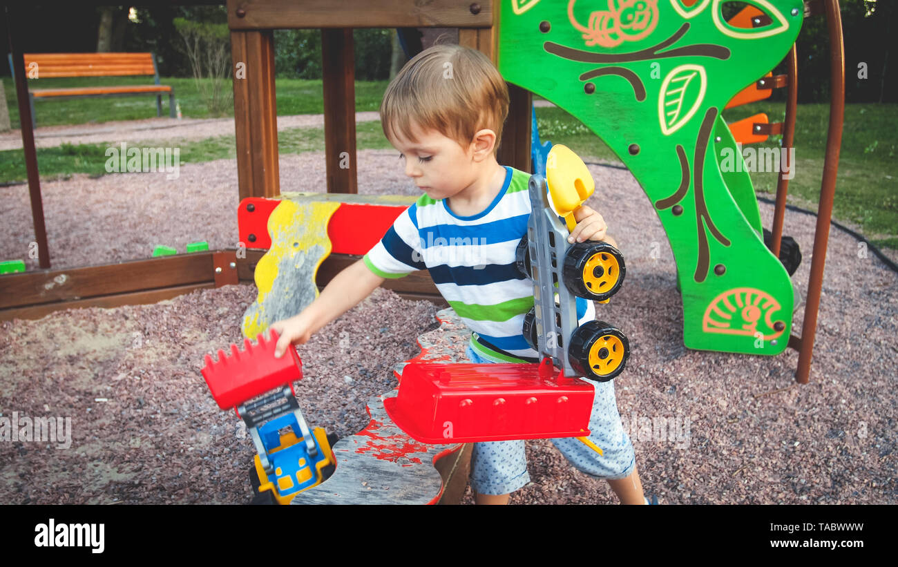 little boy with truck and trailer