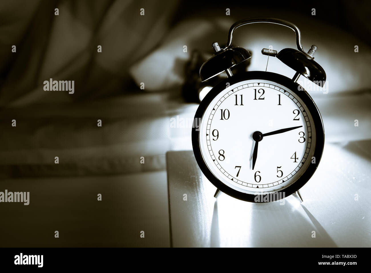 Alarm clock vintage classic alarm clock next to bed in bedroom Stock