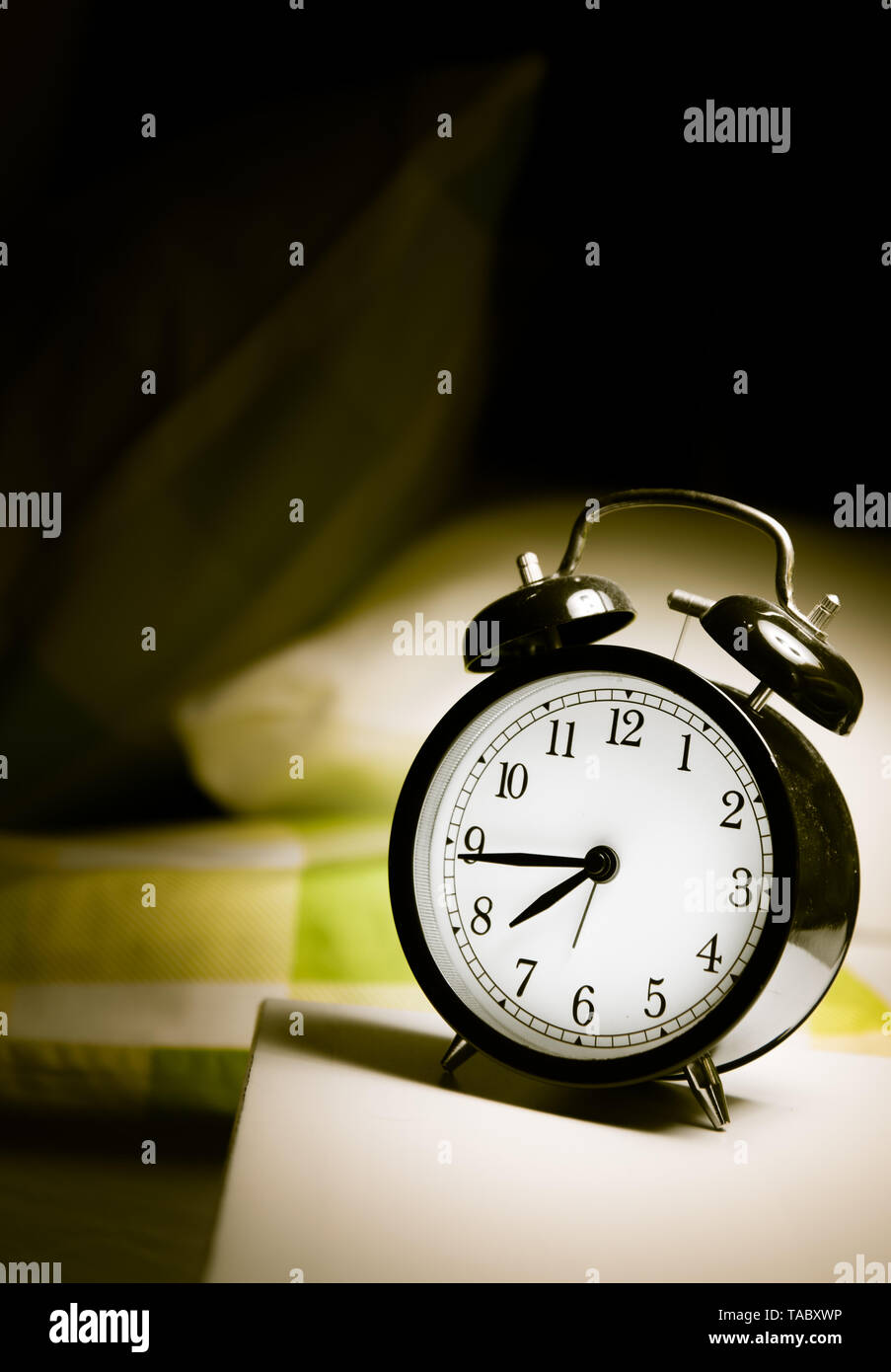 Alarm clock vintage classic alarm clock next to bed in bedroom Stock