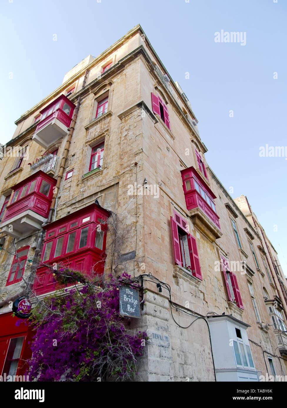 Building in Valletta with red traditional Maltese balconies, Malta Stock Photo