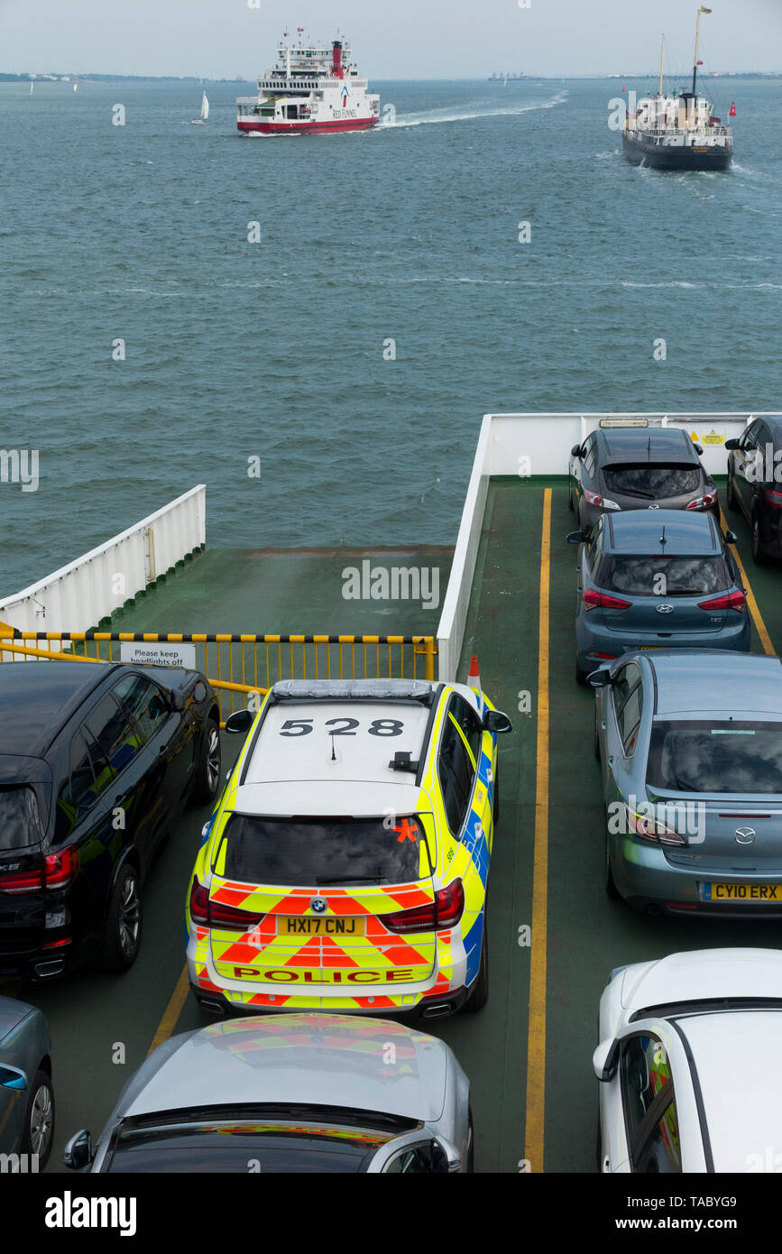 Open car deck of a Red Funnel ferry sailing between UK mainland Southampton and Cowes on the Isle of Wight. Passenger vehicles making the crossing include a police car. (99) Stock Photo