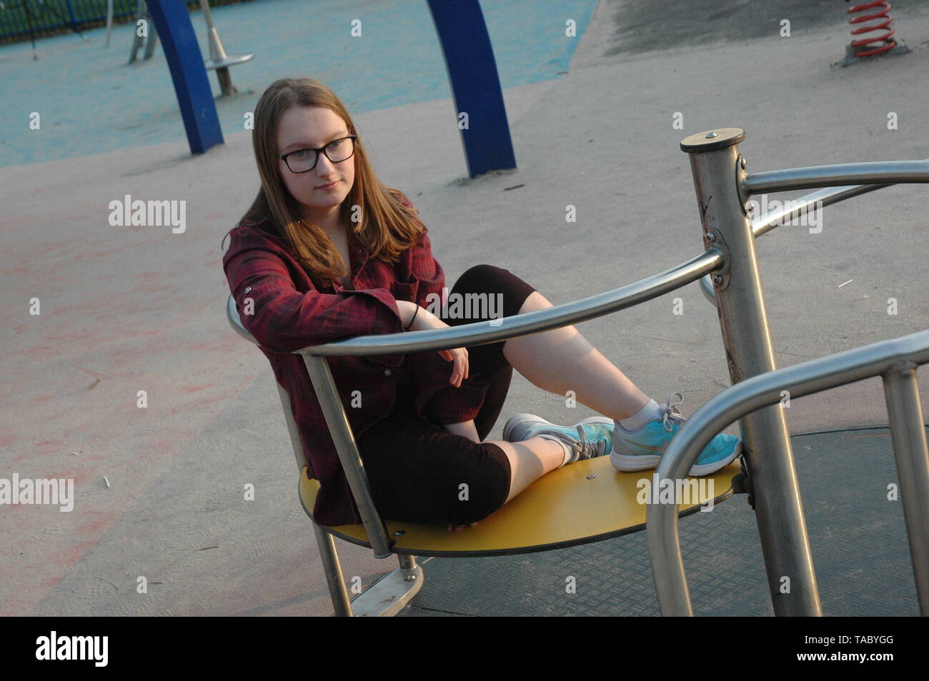 Teen girl in park sitting hi-res stock photography and images - Alamy