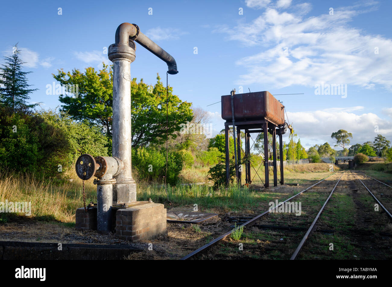 Water crane and water tower beside railway line at Glen Innes, New South Wales, Australia Stock Photo