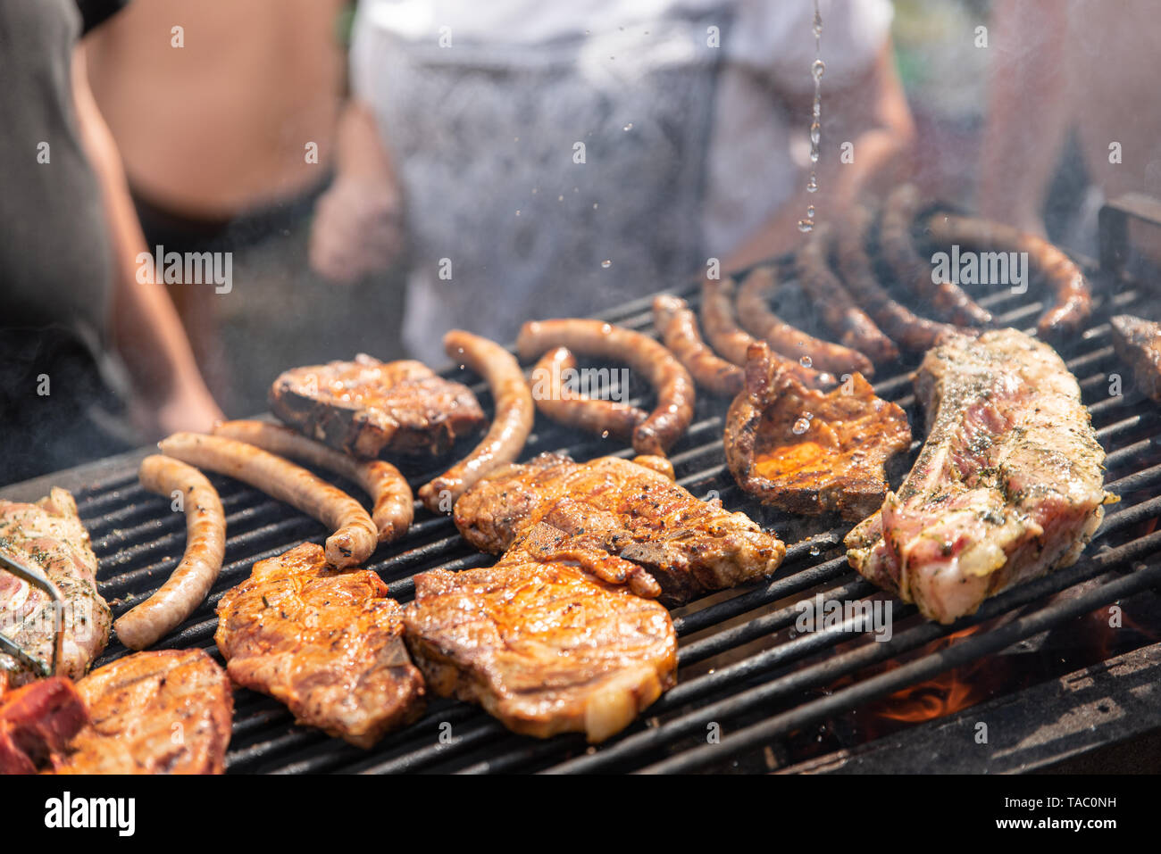 Barbecue, process of cooking meat. Rest on weekends. Friends on a