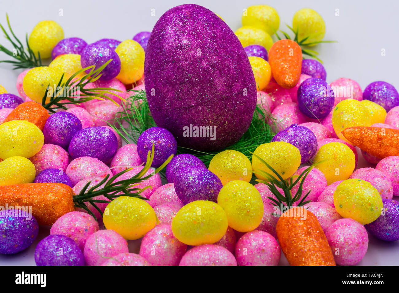 Easter props showing colorful easter egg, easter grass and mini eggs Stock Photo