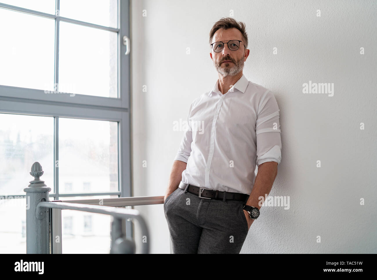 Portrait of businessman at the window in office Stock Photo