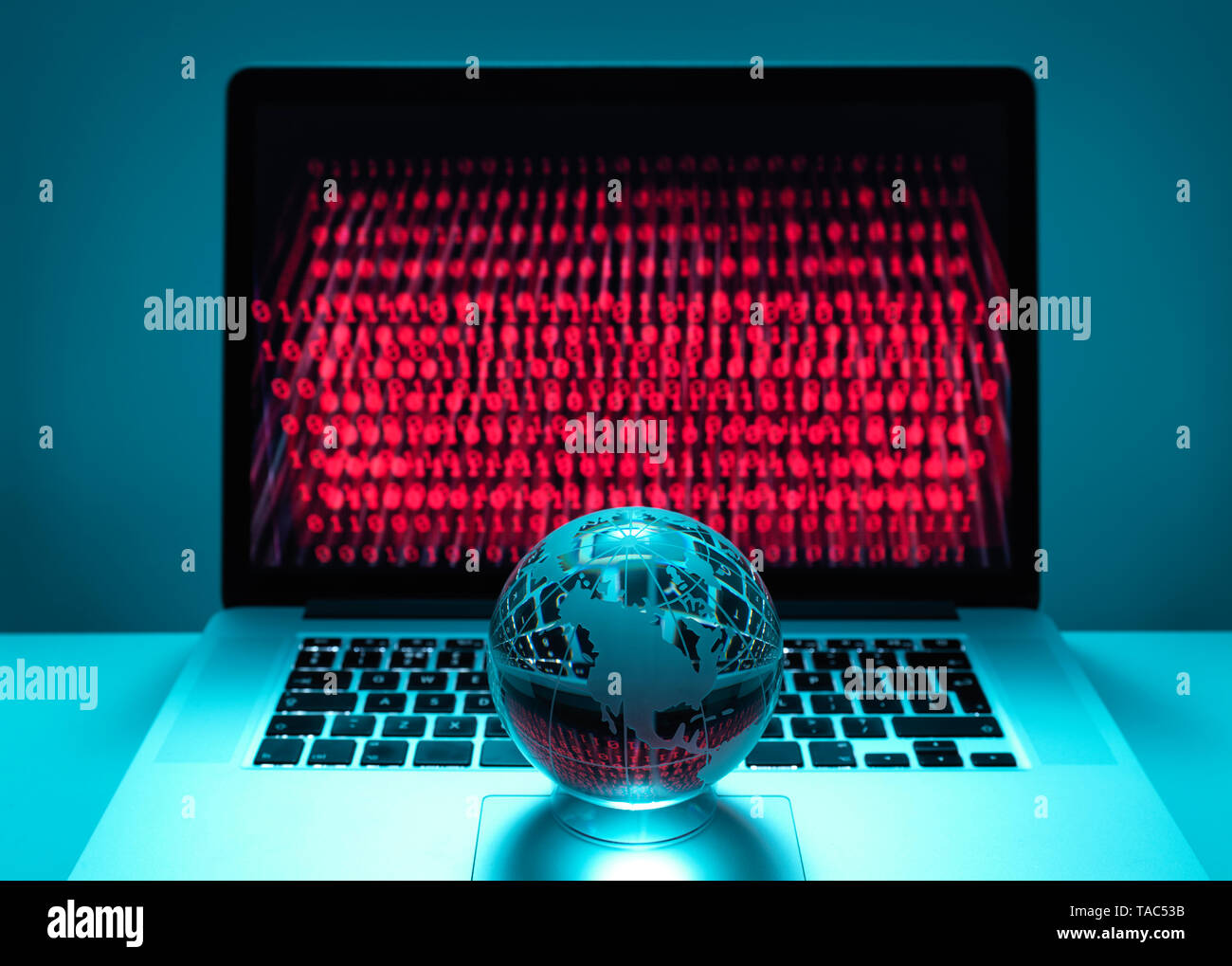 Globe illustrating the Americas on a laptop computer with screen been infected by a cyber attack Stock Photo