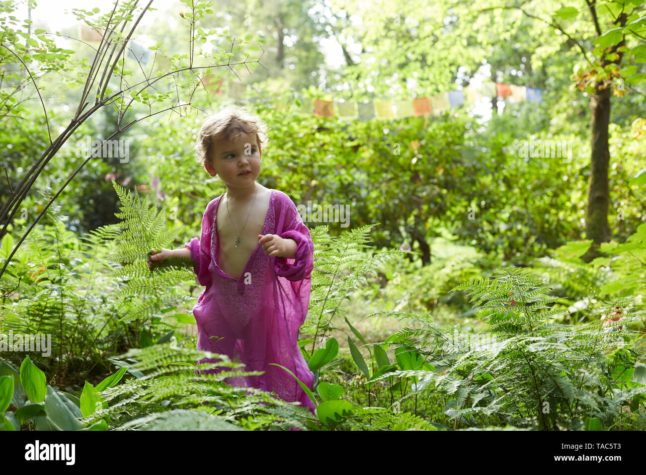 Little girl wearing pink tunic in nature Stock Photo