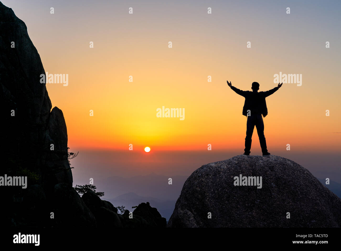 Silhouette man hands raised hi-res stock photography and images - Alamy