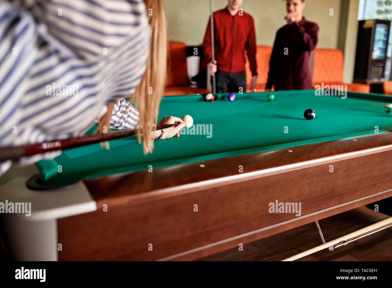 Young woman playing billiards with friends Stock Photo Alamy