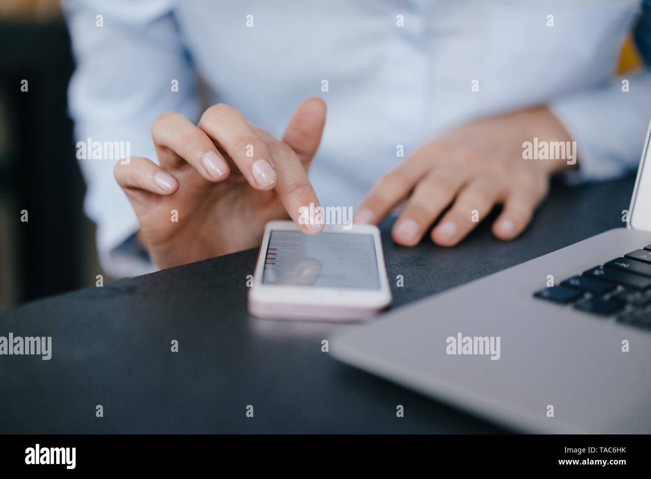 Hand of businesswoman, using smartphone Stock Photo