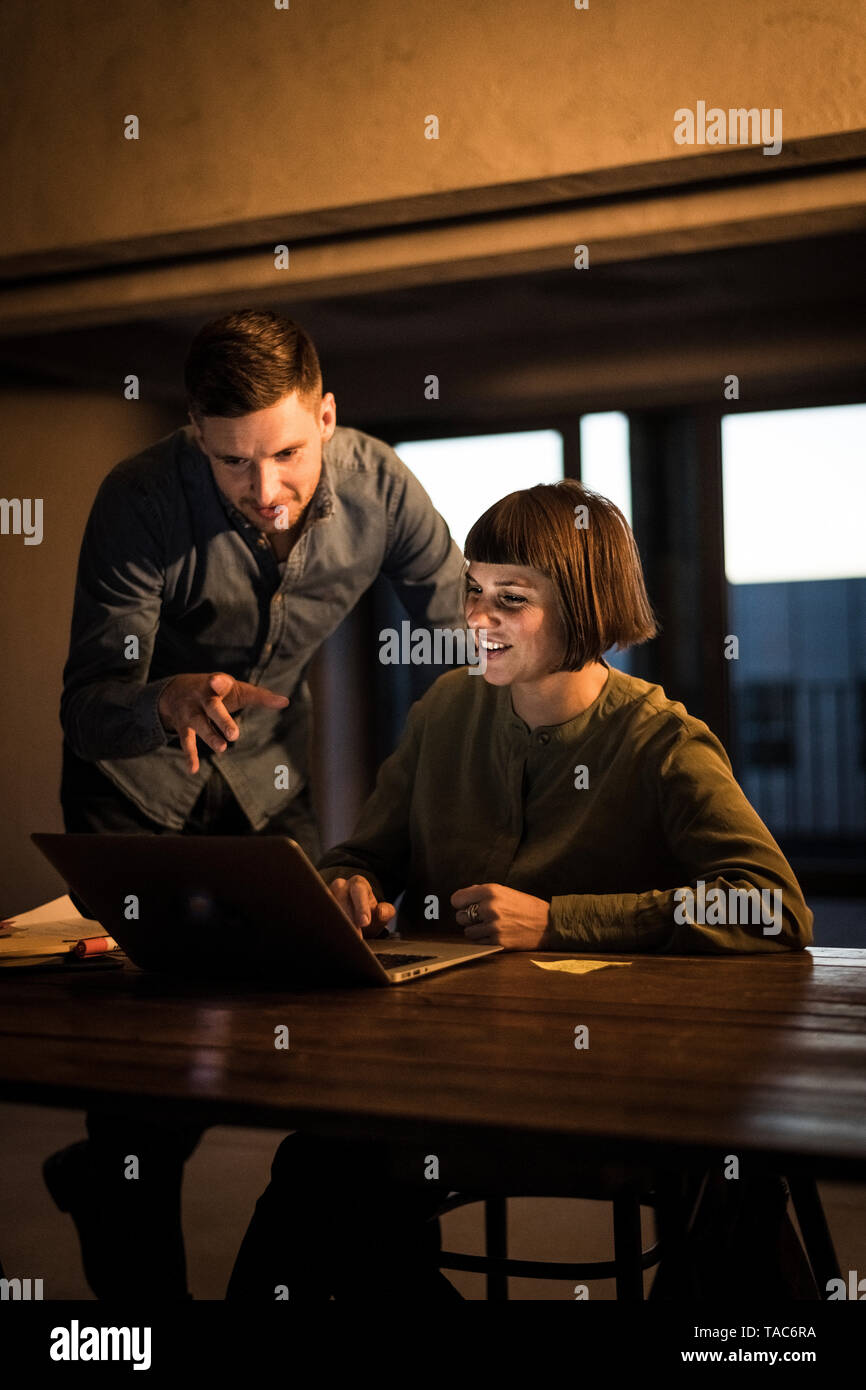 Colleagues sitting in office, working late Stock Photo