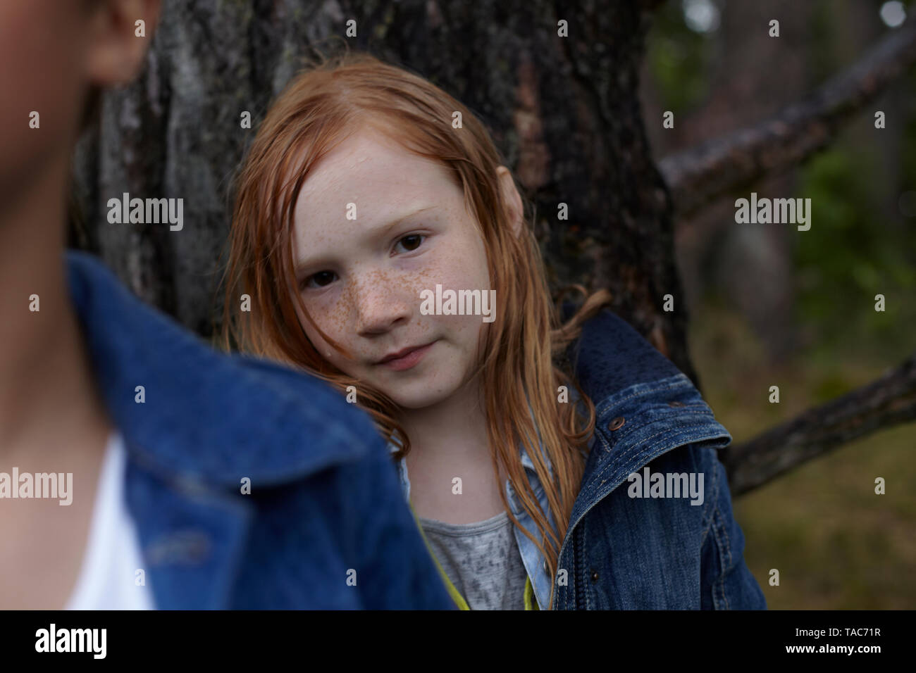 Portrait of redheaded girl at a tree Stock Photo - Alamy