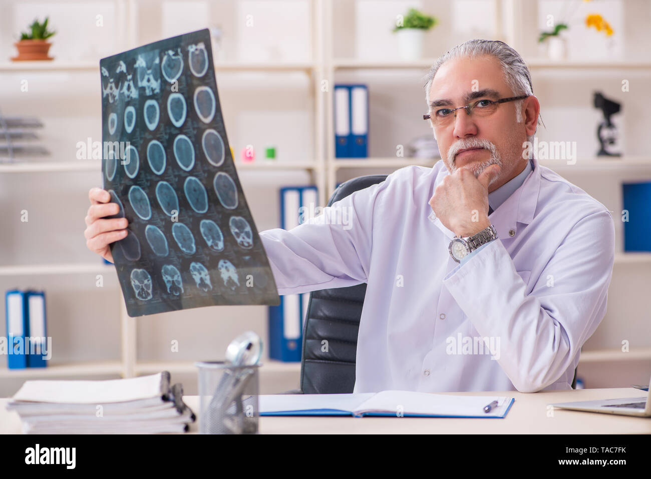 Aged male doctor radiologist in the clinic Stock Photo - Alamy