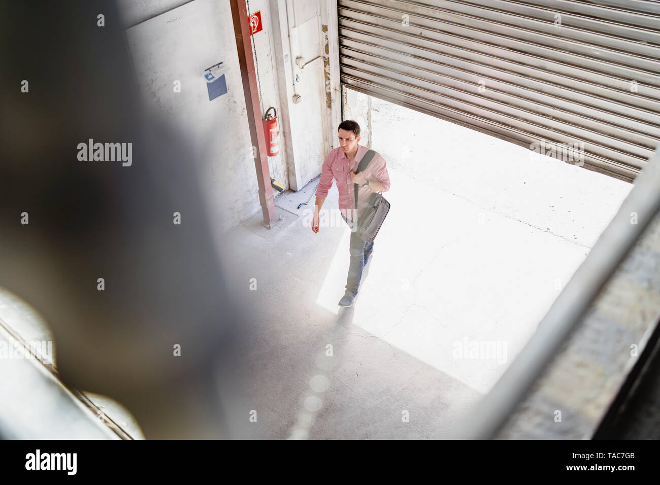 Bird's eye view of employee walking at loading bay in a factory Stock Photo