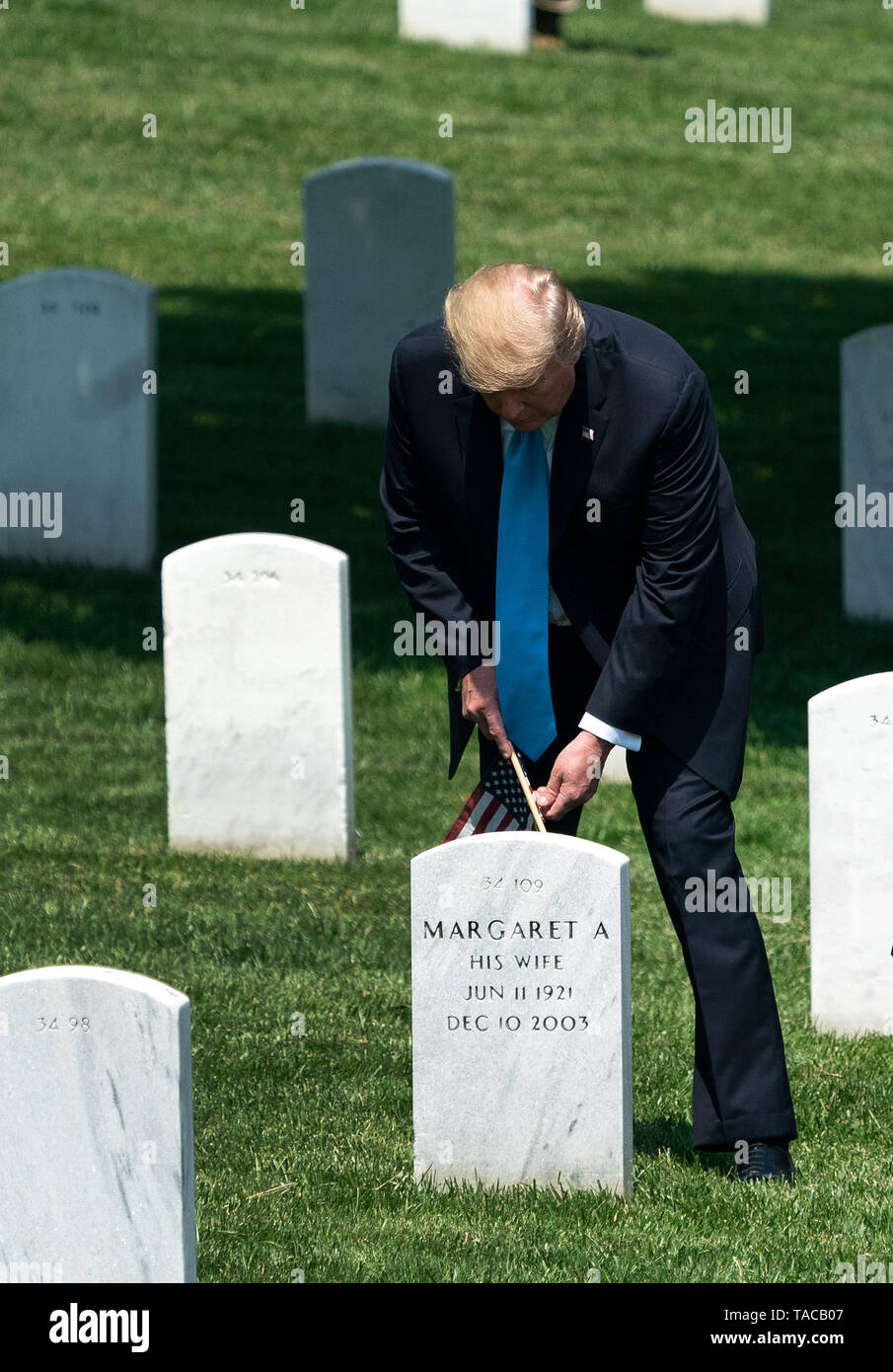 Arlington, Virginia, USA. 23rd May, 2019. United States President Donald J. Trump places a flag at a gravesite during the ''Flags-In' ceremony ahead of Memorial Day at Arlington National Cemetery, in Arlington, Virginia on May 23, 2019. ''Flags-In'' is an annual event where the 3rd U.S. Infantry Regiment, ''The Old Guard, '' places American flags at every gravesite at Arlington National Cemetery. Credit: Kevin Dietsch/Pool via CNP Credit: Kevin Dietsch/CNP/ZUMA Wire/Alamy Live News Stock Photo