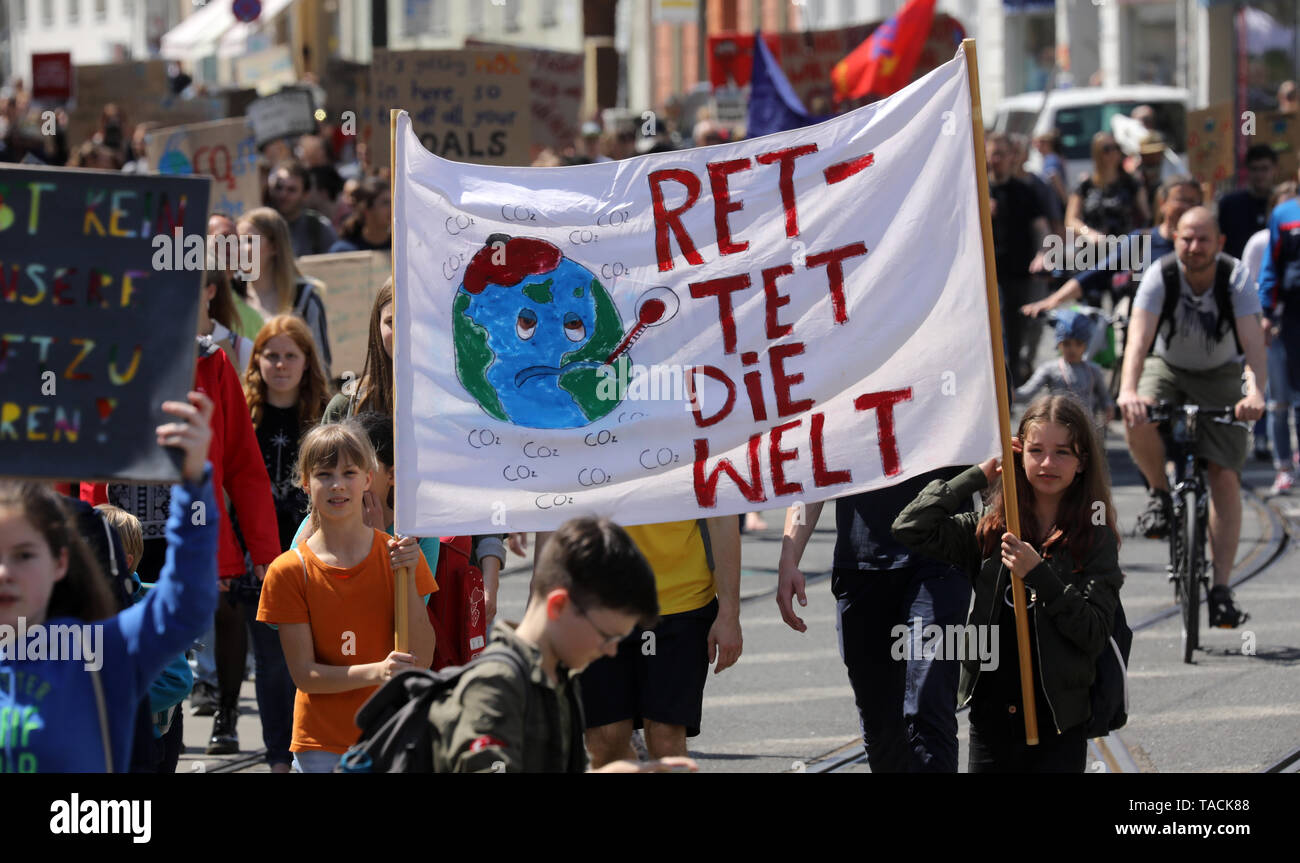 Rostock, Germany. 24th May, 2019. Pupils demonstrate with protest posters with the inscription "Save the World" during the Fridays for Future - climate strikes for the implementation of the Paris Climate Agreement. The call for demonstrations was also made against the background of the current European elections. Credit: Bernd Wüstneck/dpa/Alamy Live News Stock Photo